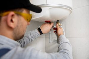 worker repairing water heater 23 2149334231